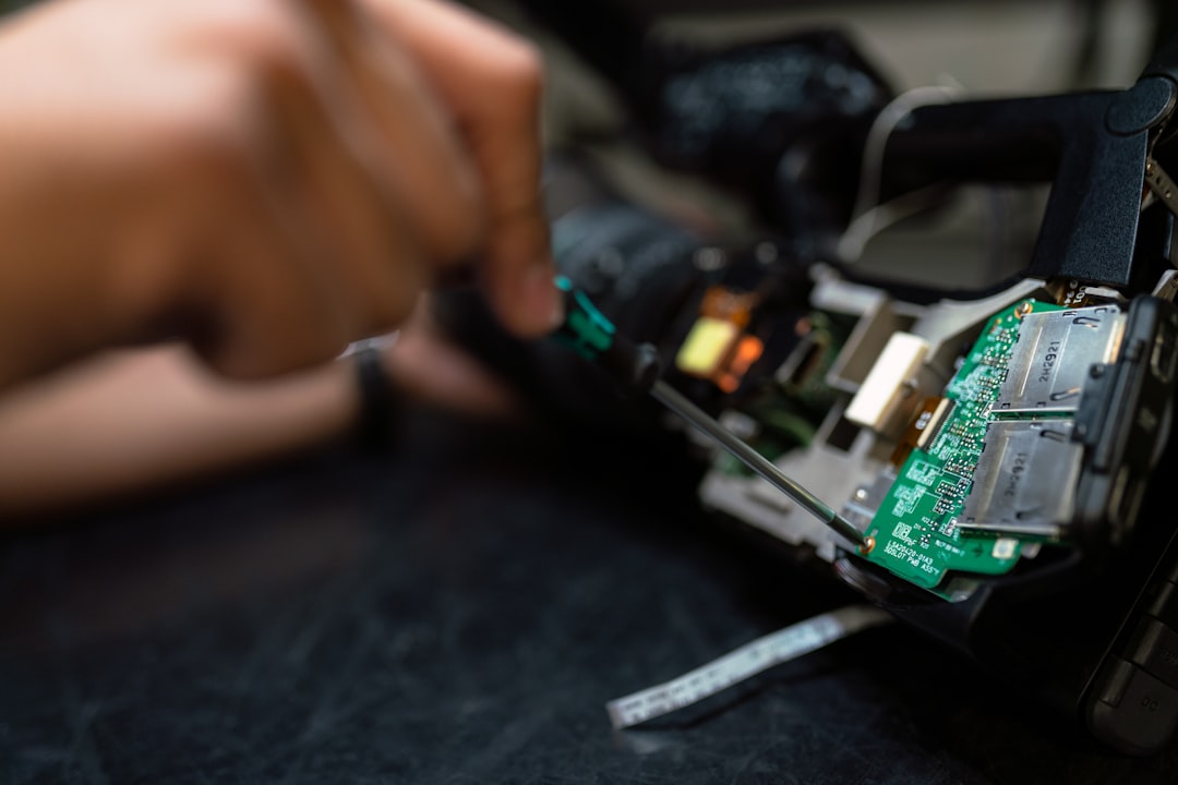 Technician inspecting and repairing internal circuitry of a television set