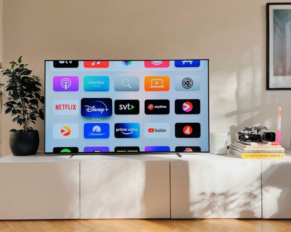 Modern smart TV showing streaming apps in a living room setting, representing LED and Smart TV repair services in Abu Dhabi